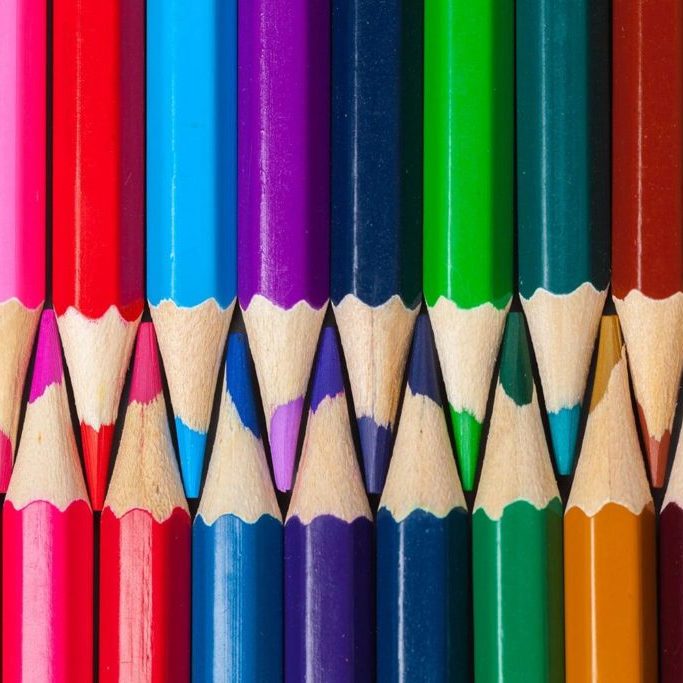 Set of colored pastel pencils in row multi color in form of closed zipper Set of colored pastel pencils in row multi color in form of closed zipper