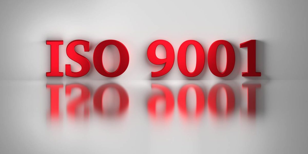 Red letters of ISO 9001 quality standard for a quality management system reflected on the white surface. ISO 9001 on white background. 3D illustration.